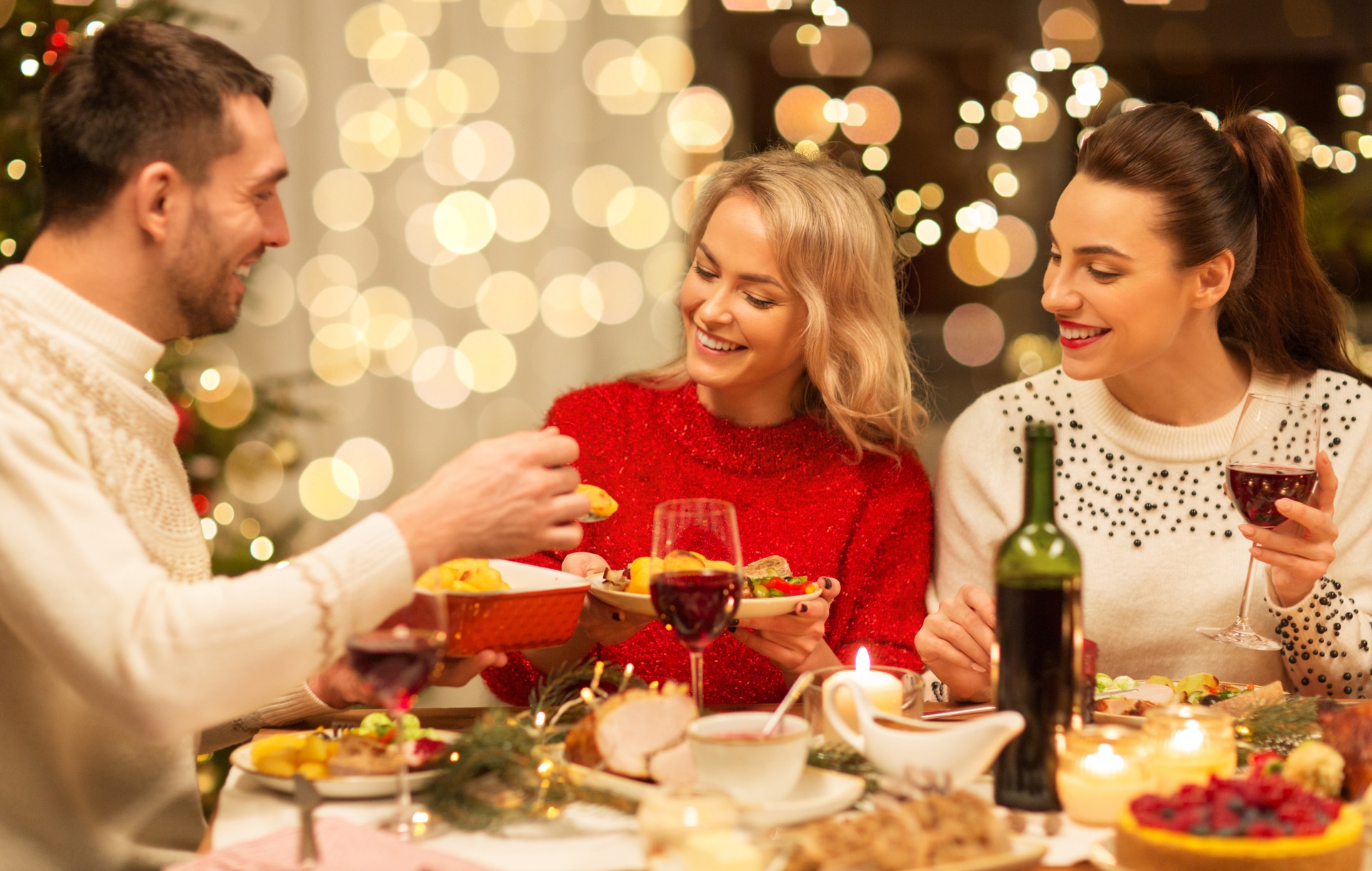 Happy friends having Christmas dinner. Holidays and Celebrations. Friends Gathering. Family Toast.